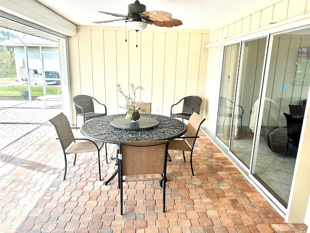 sunroom / solarium featuring ceiling fan