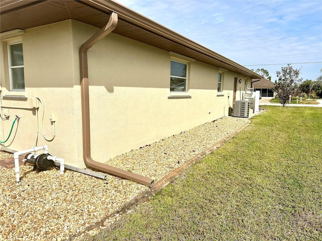 view of property exterior with a yard and cooling unit