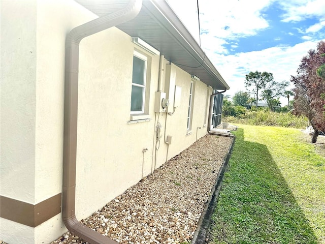 view of side of home featuring a yard