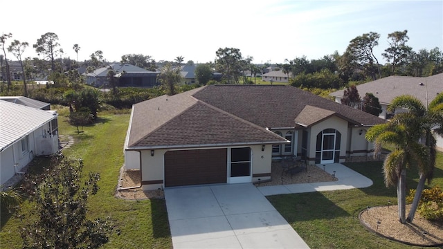 ranch-style house with a garage and a front lawn