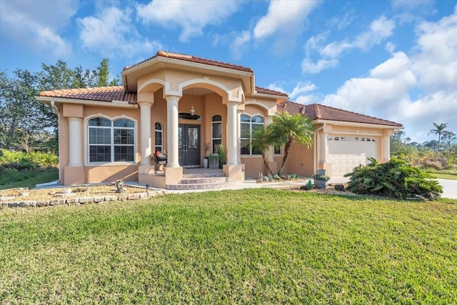 mediterranean / spanish-style home with a garage and a front lawn