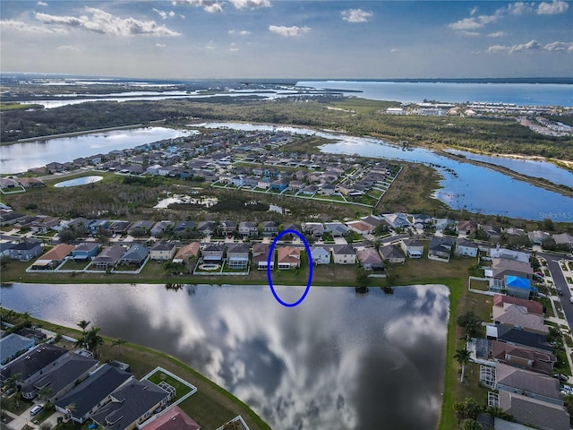 bird's eye view featuring a water view and a residential view