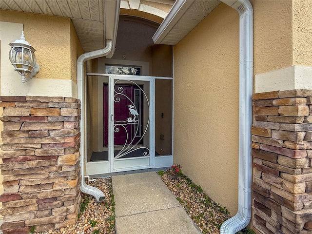 doorway to property with stucco siding