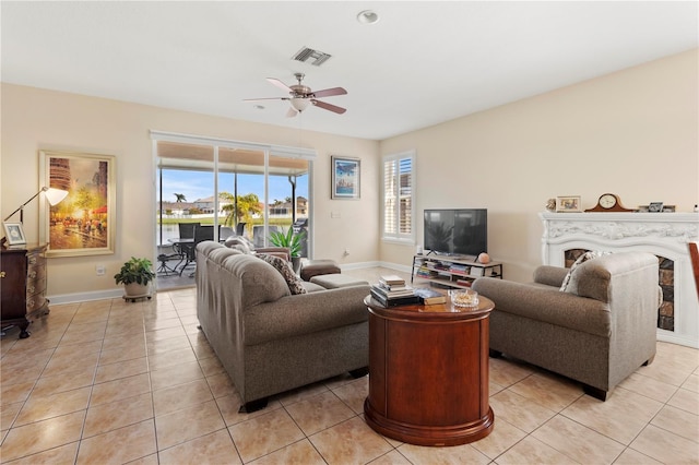 living area featuring a wealth of natural light, light tile patterned flooring, and visible vents