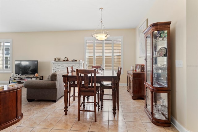 dining area with light tile patterned flooring and baseboards