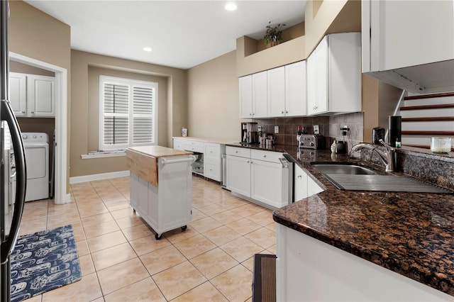 kitchen featuring white cabinets, decorative backsplash, washer / clothes dryer, light tile patterned flooring, and recessed lighting