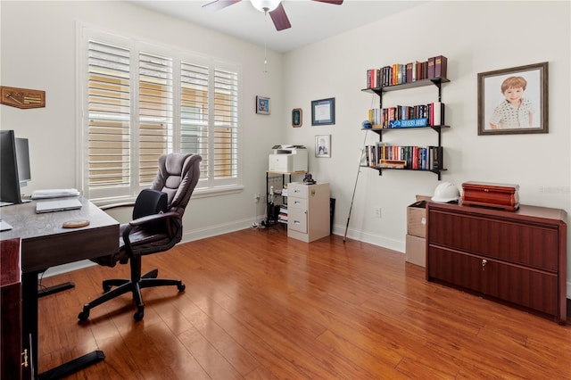 office area featuring ceiling fan, wood finished floors, and baseboards