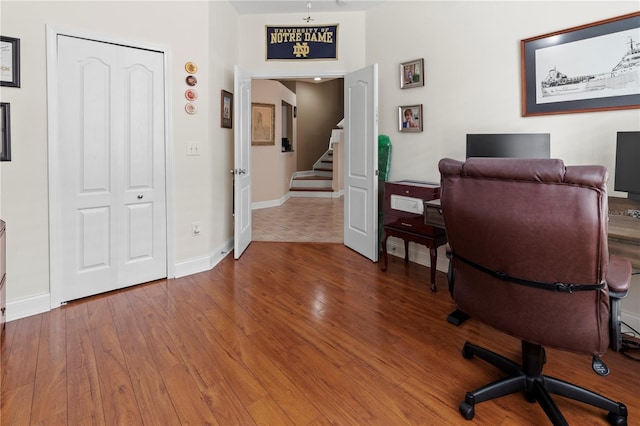 office area featuring wood-type flooring and baseboards