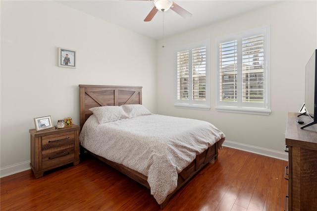 bedroom with ceiling fan, wood-type flooring, and baseboards