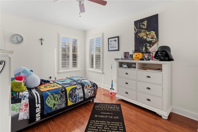 bedroom with ceiling fan, baseboards, and wood finished floors