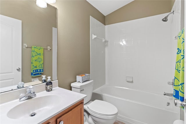 bathroom featuring toilet, vaulted ceiling, shower / tub combo with curtain, and vanity