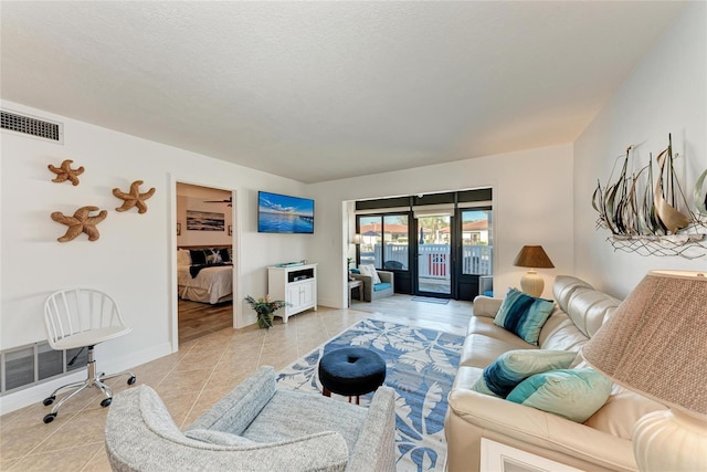 living room featuring light tile patterned flooring and a textured ceiling