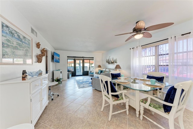 tiled dining space featuring french doors and ceiling fan