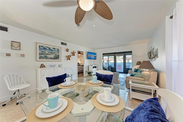 dining space featuring light tile patterned floors and ceiling fan