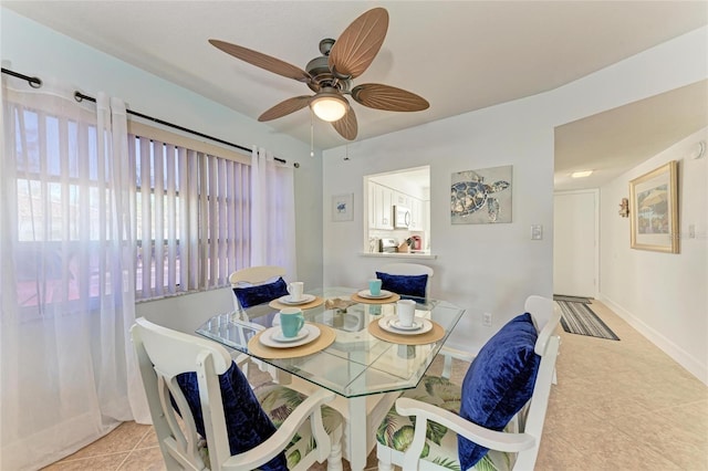 tiled dining area with ceiling fan