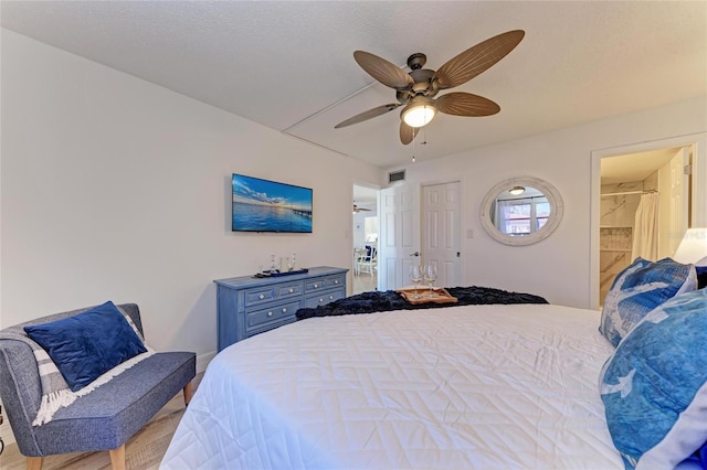 bedroom featuring a textured ceiling and ceiling fan