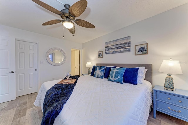 bedroom with ceiling fan and light wood-type flooring