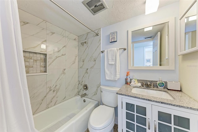 full bathroom with vanity, toilet, a textured ceiling, and shower / bath combo with shower curtain