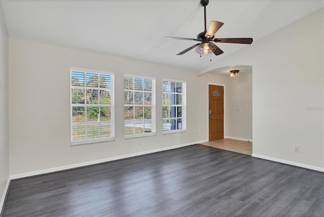 unfurnished room with lofted ceiling, dark wood-type flooring, and ceiling fan