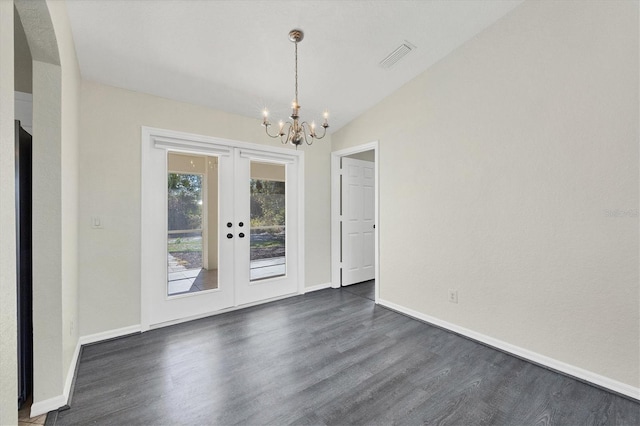 interior space featuring lofted ceiling, dark wood-type flooring, a notable chandelier, and french doors