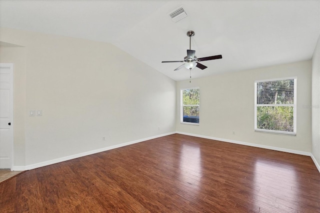 empty room featuring dark wood-type flooring, ceiling fan, and vaulted ceiling