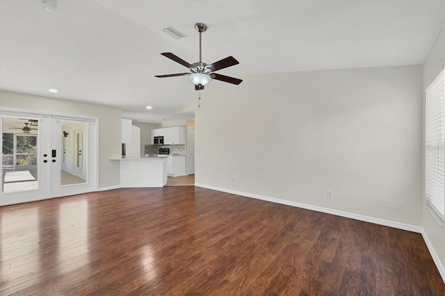 unfurnished living room with dark hardwood / wood-style flooring, lofted ceiling, and ceiling fan