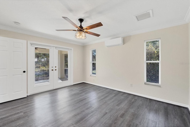 spare room featuring dark wood-type flooring, ceiling fan, a wall mounted AC, ornamental molding, and french doors