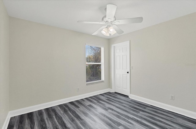 spare room featuring dark wood-type flooring and ceiling fan