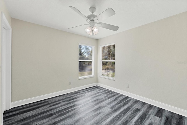 unfurnished room featuring dark wood-type flooring and ceiling fan