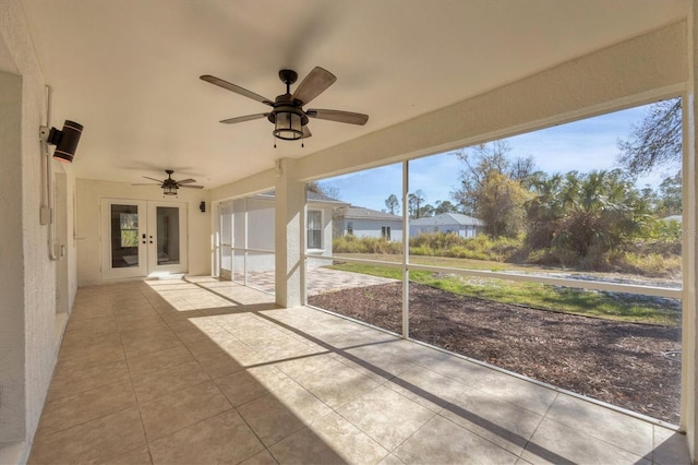 unfurnished sunroom featuring ceiling fan