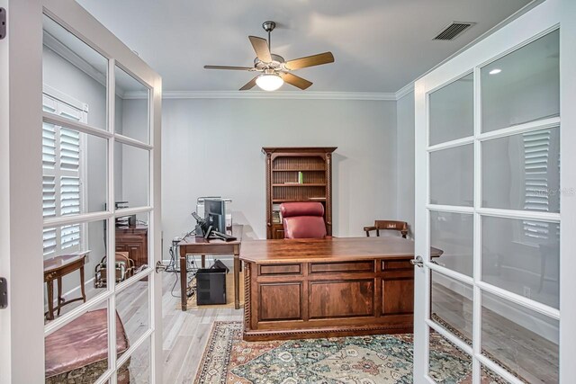 office featuring crown molding, light hardwood / wood-style floors, ceiling fan, and french doors