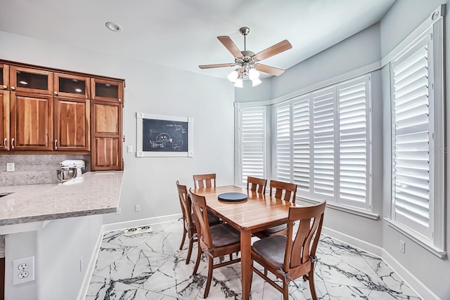 dining area with plenty of natural light and ceiling fan