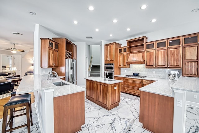 kitchen featuring sink, a breakfast bar, appliances with stainless steel finishes, custom exhaust hood, and kitchen peninsula