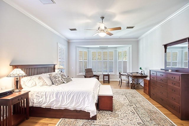 bedroom with crown molding, ceiling fan, and light wood-type flooring