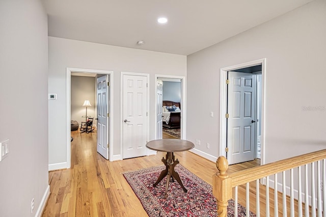 corridor with hardwood / wood-style floors