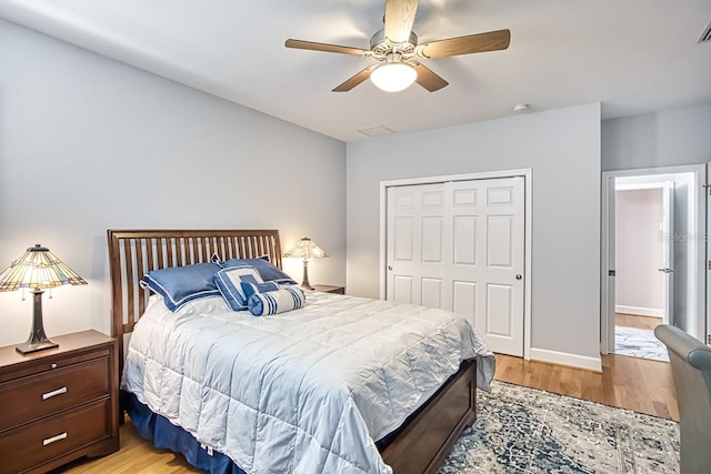 bedroom with a closet, ceiling fan, and light wood-type flooring