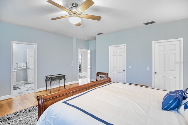 bedroom featuring connected bathroom, ceiling fan, and light wood-type flooring