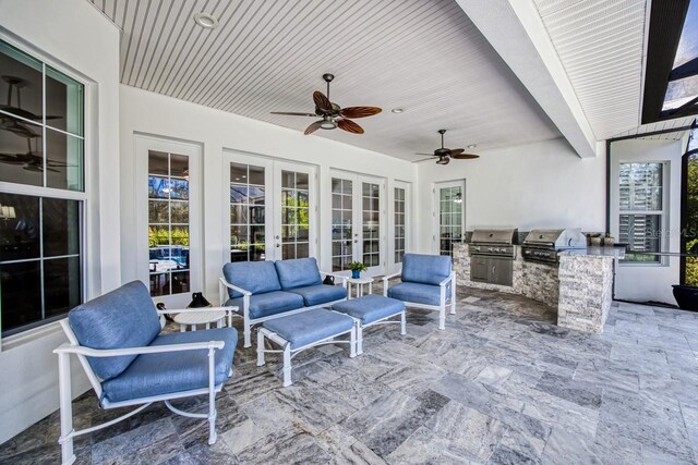 view of patio with exterior kitchen, area for grilling, ceiling fan, and french doors