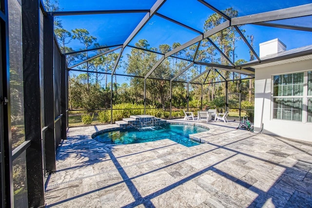 view of swimming pool featuring pool water feature, glass enclosure, and a patio