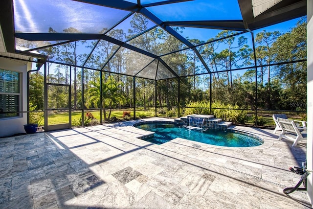 view of pool featuring a jacuzzi, a patio area, pool water feature, and glass enclosure