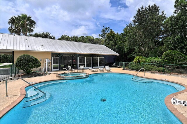 view of swimming pool with a community hot tub and a patio