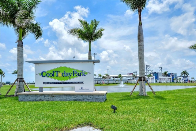 exterior space featuring a water view and a lawn