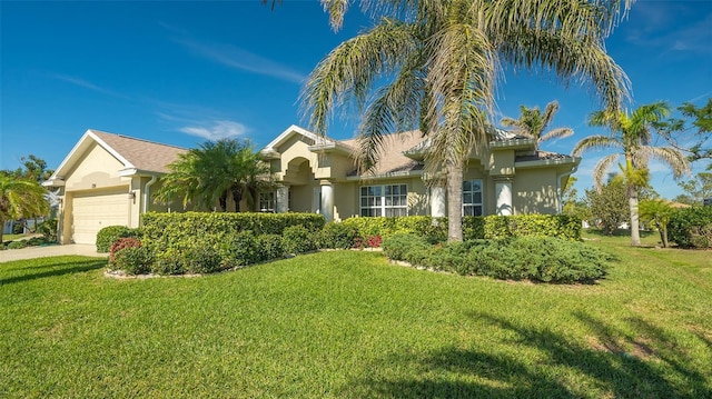 view of front facade with a garage and a front lawn