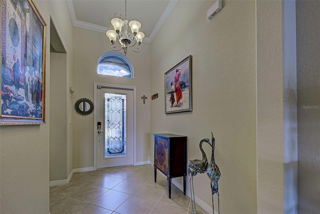 tiled entrance foyer featuring crown molding and a chandelier