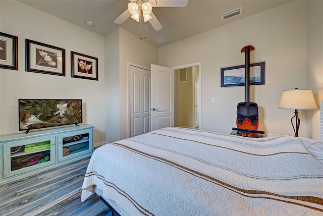 bedroom featuring hardwood / wood-style flooring, ceiling fan, and a closet