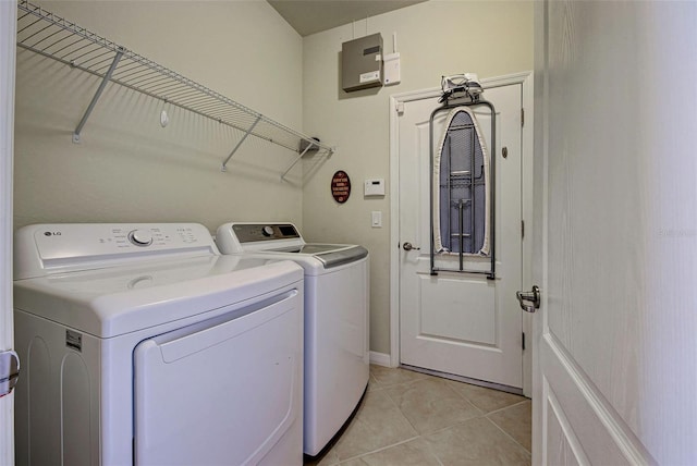 washroom featuring washer and clothes dryer and light tile patterned floors