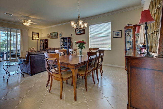 tiled dining area with crown molding, ceiling fan with notable chandelier, and a healthy amount of sunlight