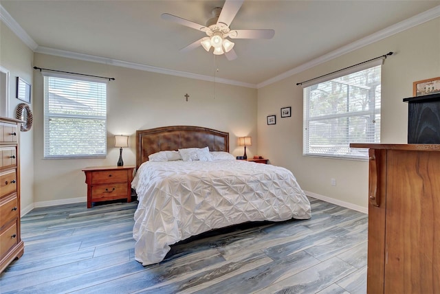 bedroom with hardwood / wood-style floors, ornamental molding, and ceiling fan