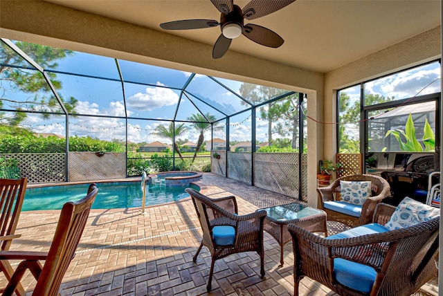 view of swimming pool with an in ground hot tub, ceiling fan, a lanai, and a patio