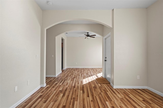 empty room with ceiling fan and light wood-type flooring